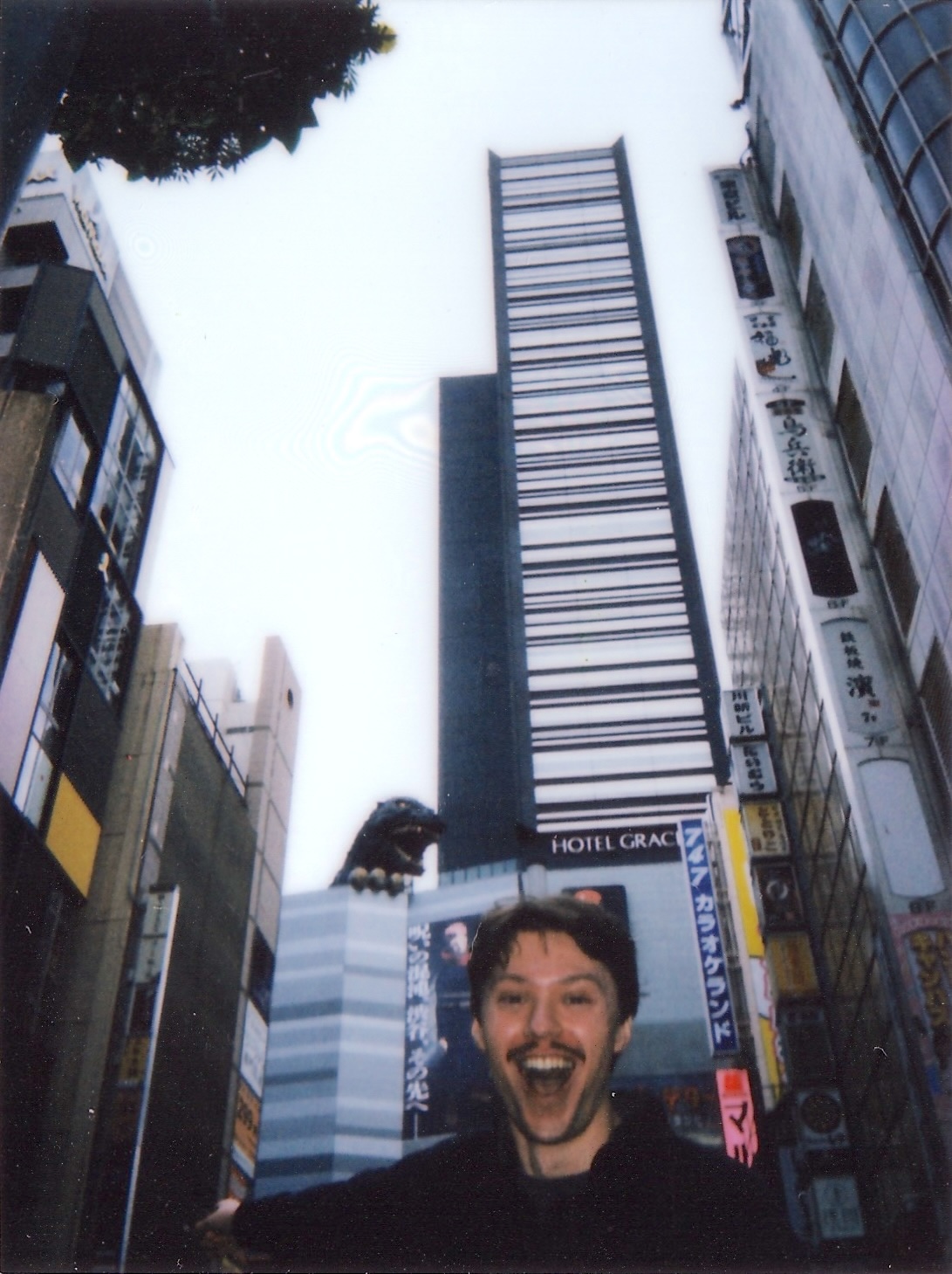 Max in front of Godzilla hotel statue in Tokyo, Japan